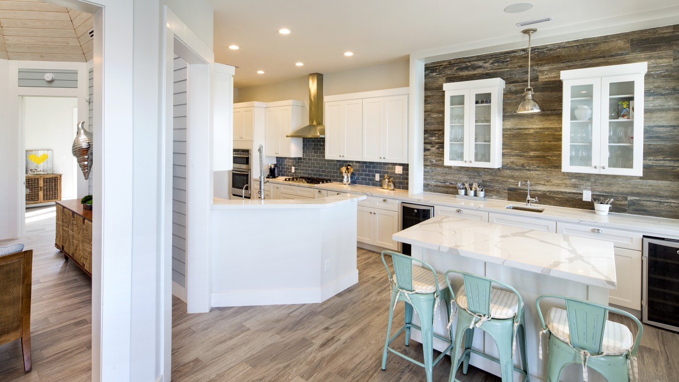 Modern kitchen with marble island and reclaimed wood accent wall