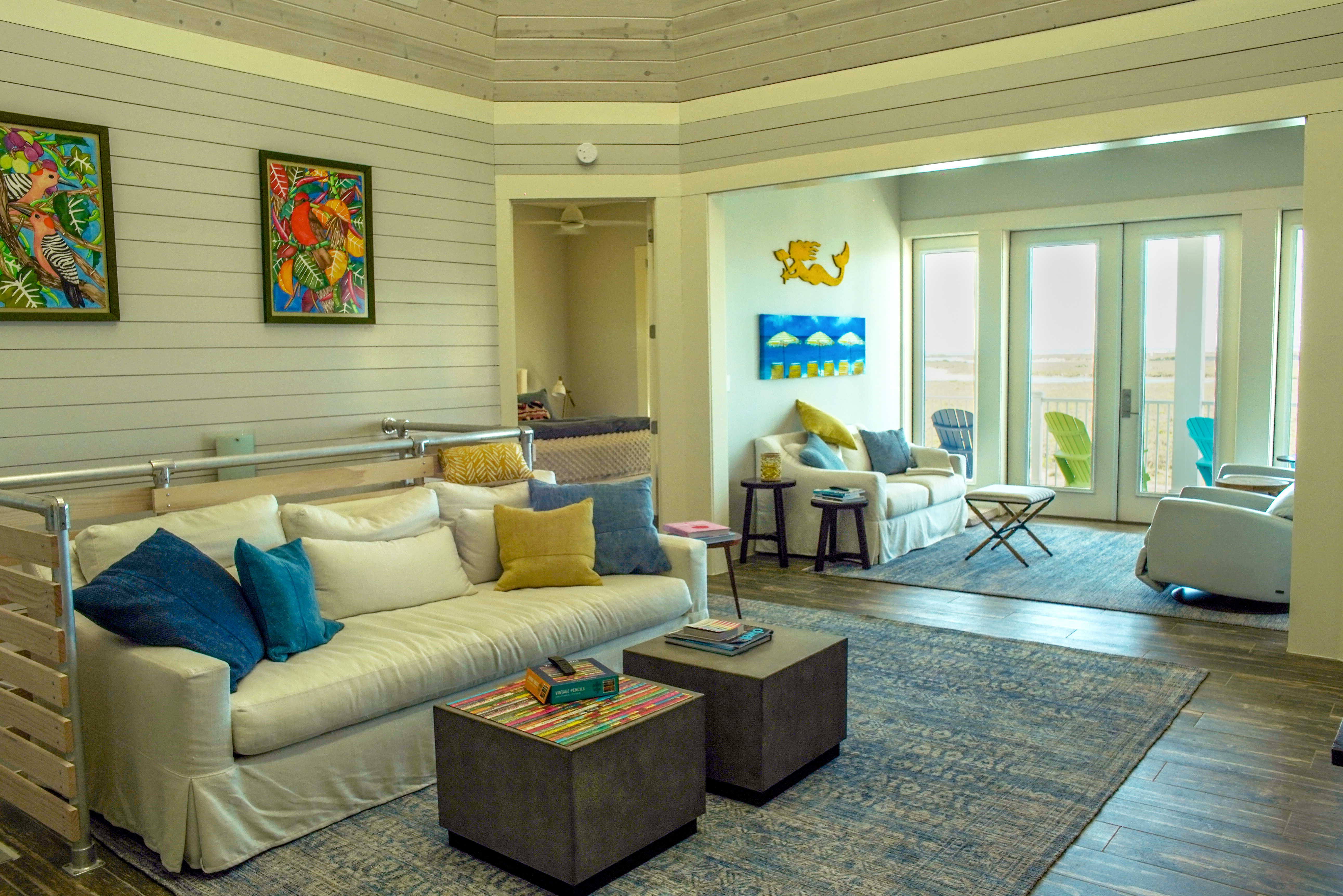 Living area with colorful artwork and water views