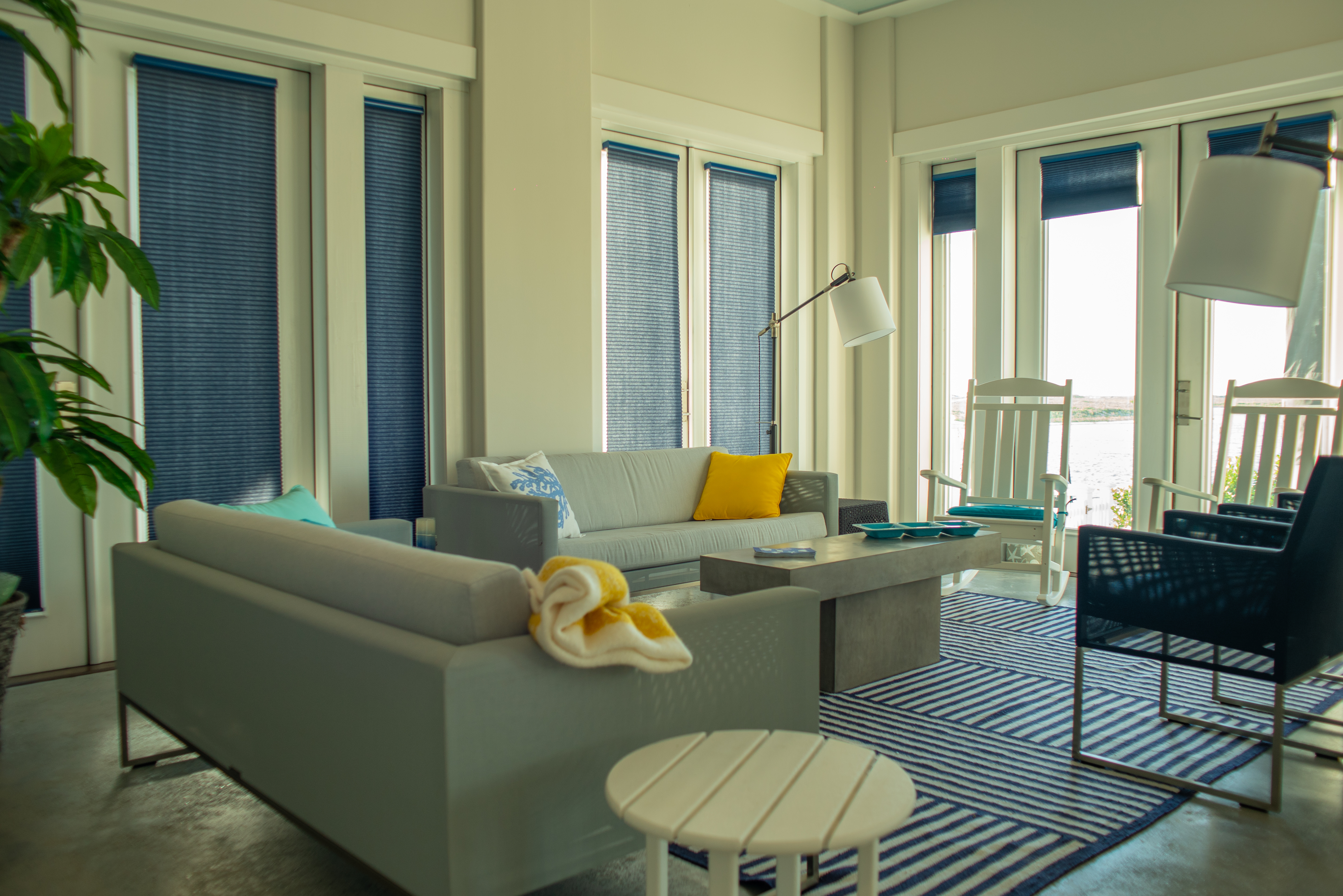 Modern living room with striped rug and water views