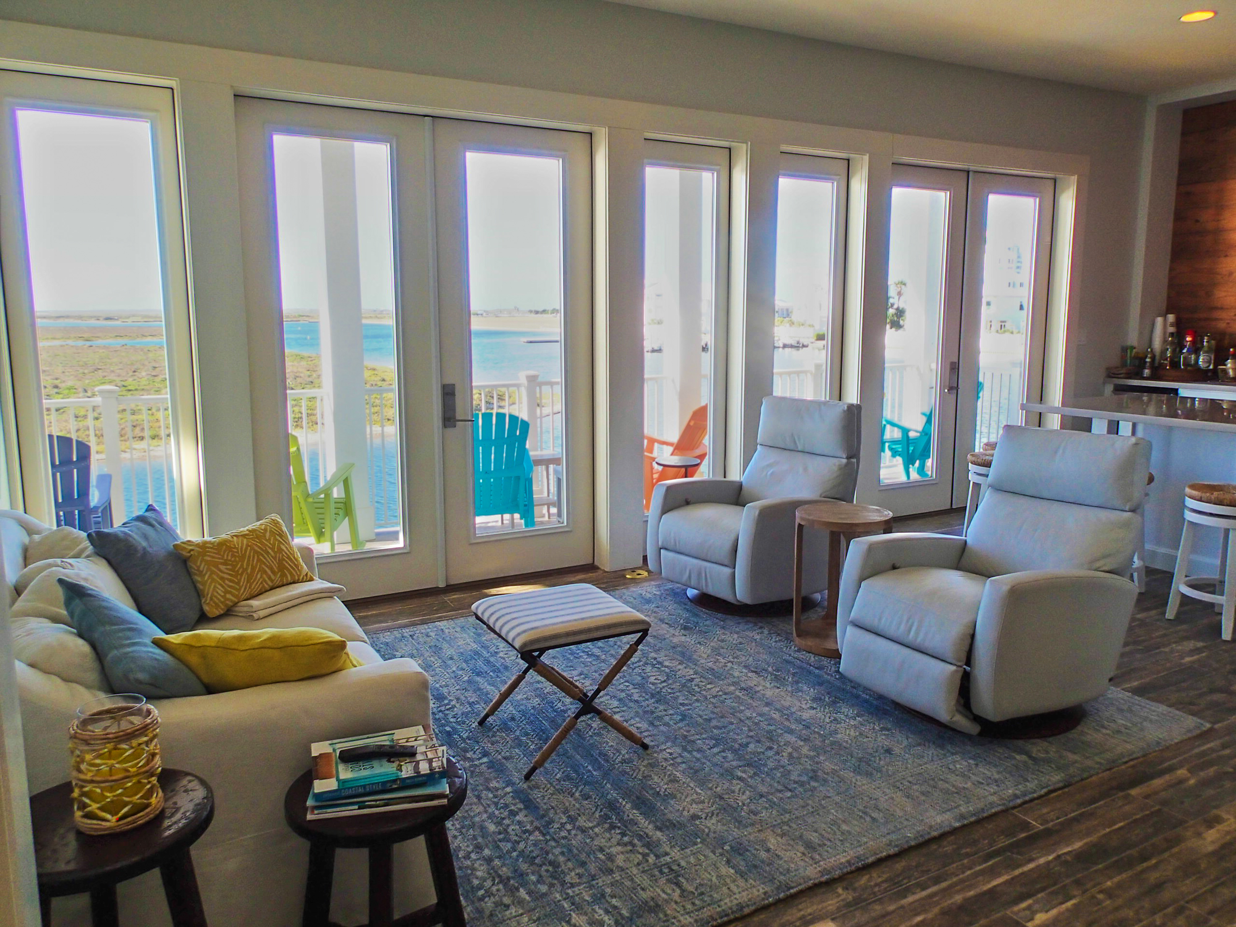 Living room with floor-to-ceiling windows and balcony overlooking the water